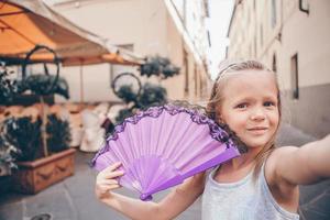 Adorable fashion little girl outdoors in European city photo