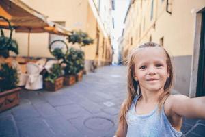 Adorable fashion little girl outdoors in European city photo