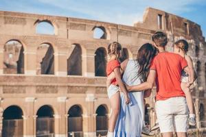 Happy family in Rome over Coliseum background. photo