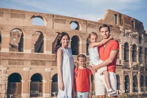 Happy family in Rome over Coliseum background. photo