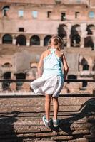 Happy toddler girl in Rome over Coliseum background photo