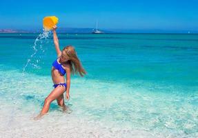 Little happy girl enjoying beach vacation photo