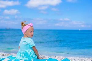 Adorable little girl at tropical beach during summer vacation photo