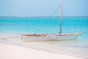 Old wooden dhow in the Indian Ocean near Zanzibar photo