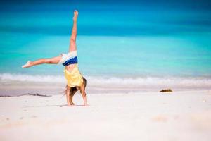 Adorable little girl at beach during summer vacation photo