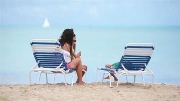 Mother with two kids enjoy beach vacation video