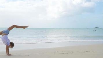 Active little girl at beach having a lot of fun. video