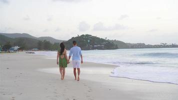Young couple on white beach during summer vacation. Happy family enjoy their honeymoon video