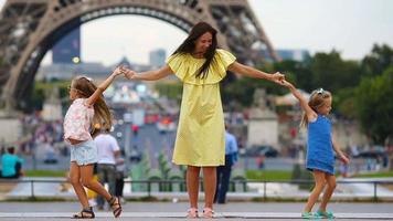 Happy family in Paris near Eiffel tower. French summer holidays, travel and people concept. video
