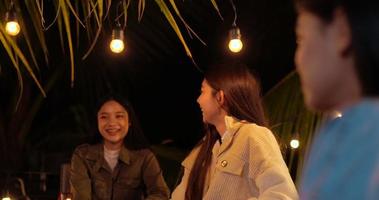 filmagem de amigos asiáticos felizes jantando juntos - jovens brindando ao jantar com copos de cerveja ao ar livre - pessoas, comida, estilo de vida de bebida, conceito de celebração de ano novo. video