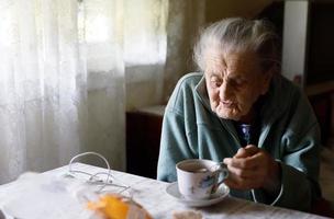 Elderly lonely woman photo