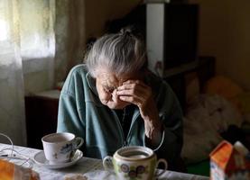 Elderly lonely woman photo