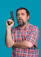 Portrait of a handsome man holding a gun photo