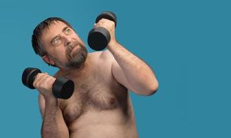 elderly fat man exercising with dumbbells photo