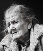 Very old and tired wrinkled woman outdoors photo