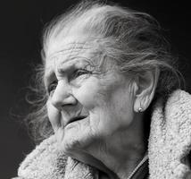 Very old and tired wrinkled woman outdoors photo