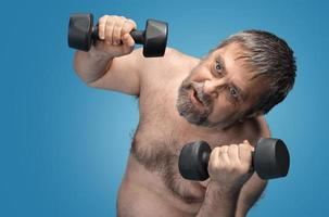 man exercising with dumbbells photo