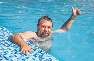 Middle-aged man in a swimming pool photo