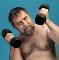 man exercising with dumbbells photo