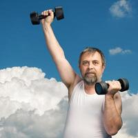 man exercising with dumbbells photo