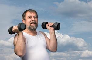 man exercising with dumbbells photo