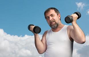 man exercising with dumbbells photo