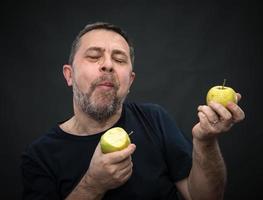 Middle-aged man with a green apples photo