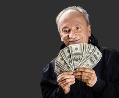 Senior gentleman holding a stack of money photo