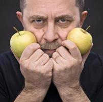 middle-aged man with a green apples photo