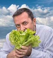 Man holding lettuce isolated on white photo