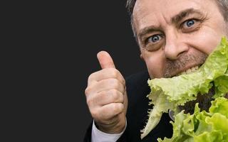 Man holding and eating lettuce photo