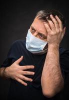 sick old man in medical mask photo