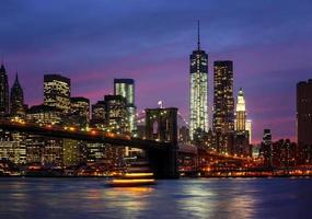 Manhattan at night with lights and reflections photo