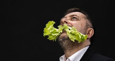 Man holding and eating lettuce photo