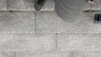 Runner athlete in green sneakers and pants, running on the stairs. Endurance cardio exercise. Running with your feet. Fitness, running up the stairs. Close-up top view of a man's feet. video