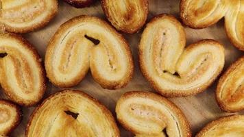 Rotating close up of fresh palm puff pastry in the shape of a heart. French biscuits with elephant ears. Close-up. video