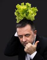 Man holding and eating lettuce photo