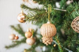 Christmas pine tree with decorative golden ball and bauble ornamental photo