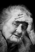 Very old and tired wrinkled woman outdoors photo