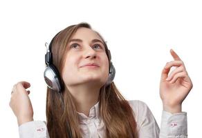 Girl listening to music in headphones photo