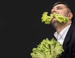 Man holding and eating lettuce photo