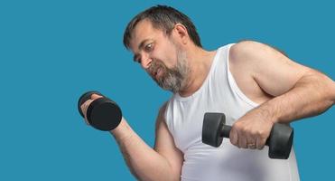 man exercising with dumbbells photo