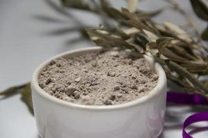 bowl with ashes and olive branch. ash wednesday concept photo