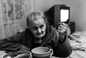 old woman threatening by fist photo