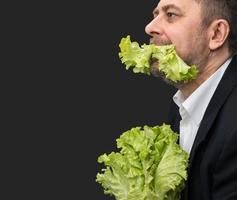 Man holding and eating lettuce photo