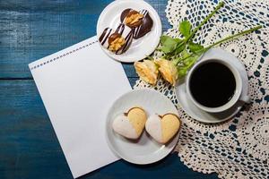 romantic coffee background with sweet cookies and roses with salutations photo