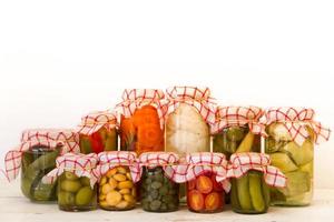 variety of jars with organic vegetable pickles photo