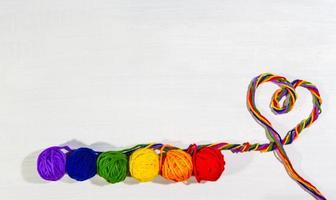 wool balls that form the heart of diversity on white background photo