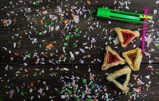 Jewish carnival concept Haman ears, masks, noisemakers, confetti photo