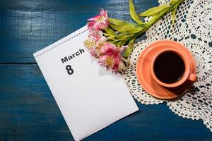 cup of coffee with flowers and note with place for text photo